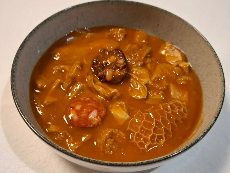 Stewed tripe in sauce with chorizo and black pudding